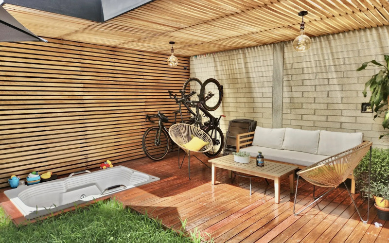 Experience tranquility in this private garden featuring a stylish deck and jacuzzi, perfect for outdoor relaxation and entertaining. Enjoy the serene atmosphere and create your own oasis in this beautiful space.