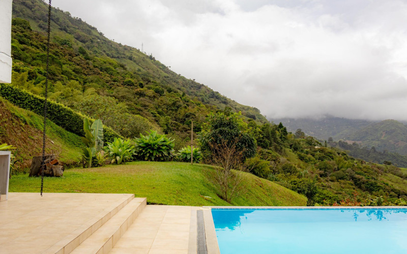 High-yield luxury villa near Medellin: 6 BR, pool, and incredibly low $23 USD annual taxes.