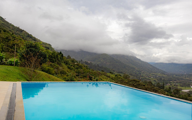 High-yield luxury villa near Medellin: 6 BR, pool, and incredibly low $23 USD annual taxes.