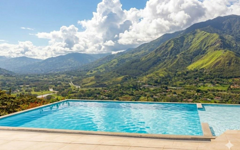 High-yield luxury villa near Medellin: 6 BR, pool, and incredibly low $23 USD annual taxes.